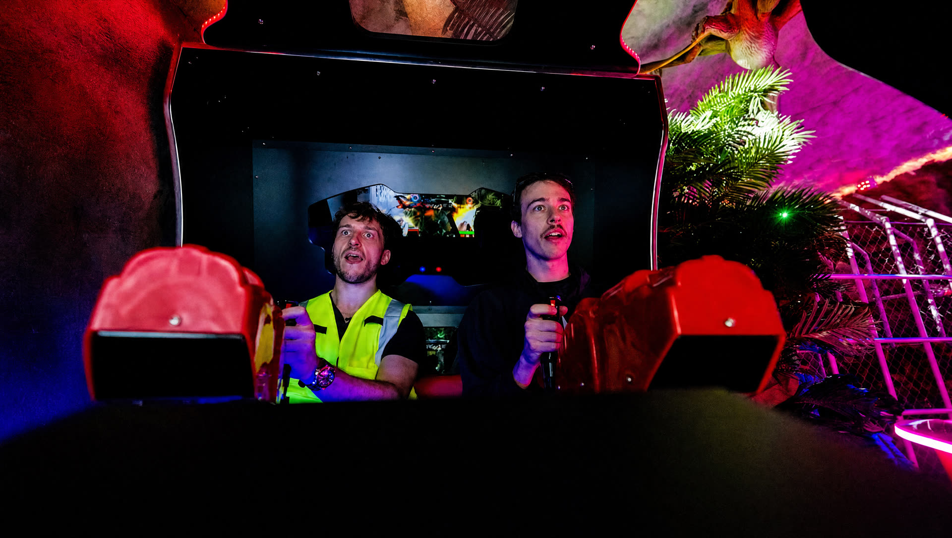 FrenchieFries and a friend in the racing seats of the Jurassic Game Room